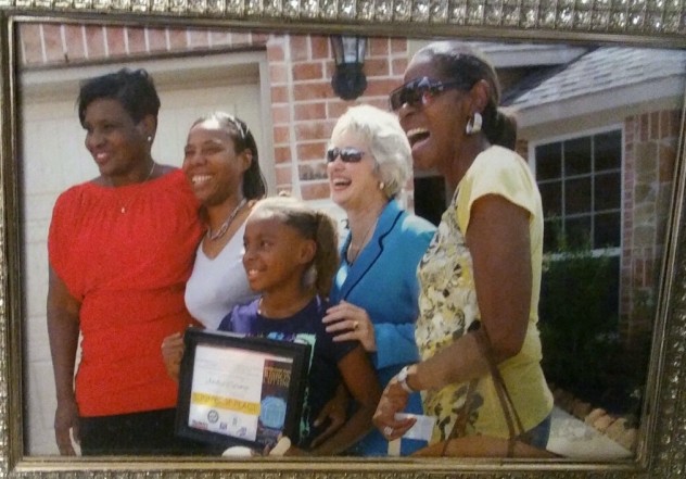 Caraway keeps this framed photo from the day of her signing on her kitchen counter. Left to right: then-City Council Member Wanda Adams, Caraway and her daughter, then-Mayor Annise Parker and Caraway's mother.