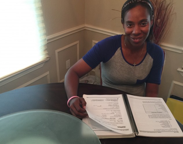 Caraway signing the paperwork to close on her home.